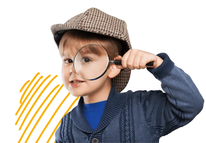 Un niño examina atentamente algo a través de una lupa, mostrando curiosidad y sed de conocimiento.